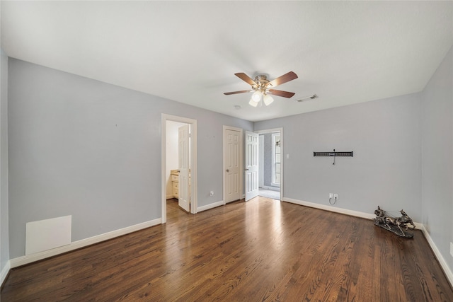 spare room featuring a ceiling fan, baseboards, visible vents, and wood finished floors