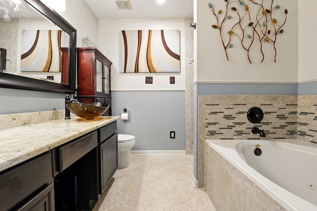 full bathroom with vanity, a bath, toilet, visible vents, and baseboards
