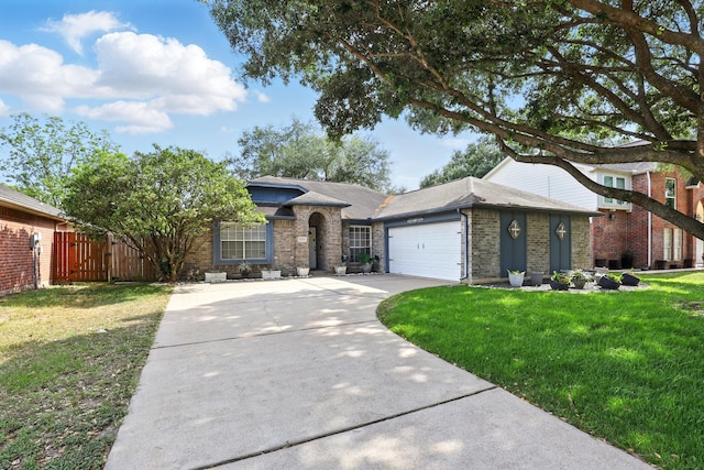 single story home with brick siding, a front yard, concrete driveway, and an attached garage