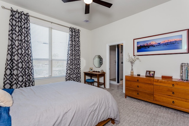 bedroom featuring visible vents, ceiling fan, light carpet, and multiple windows