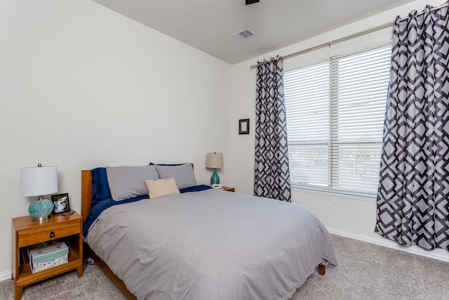carpeted bedroom with baseboards and visible vents