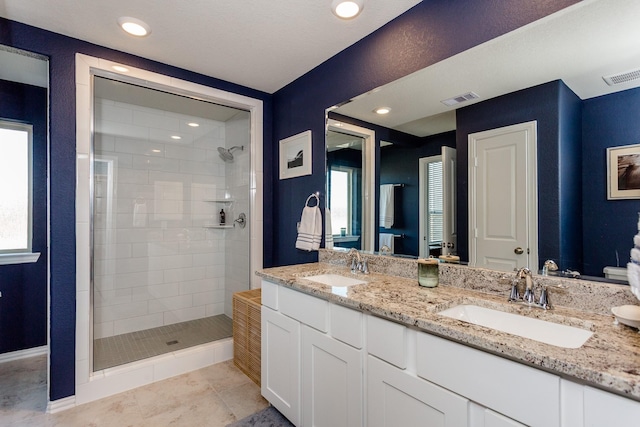 full bath featuring visible vents, a shower stall, and a sink