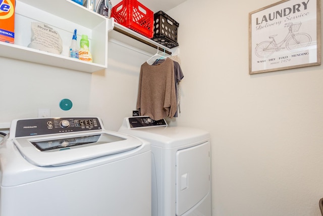 clothes washing area featuring separate washer and dryer and laundry area