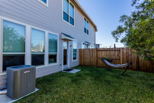 view of yard with fence and central air condition unit