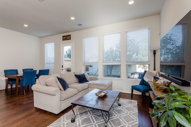 living room featuring wood finished floors, recessed lighting, visible vents, and baseboards