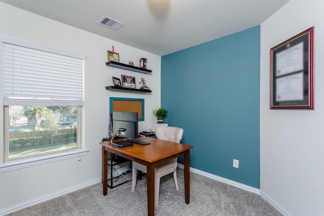 office space with visible vents, baseboards, and carpet floors
