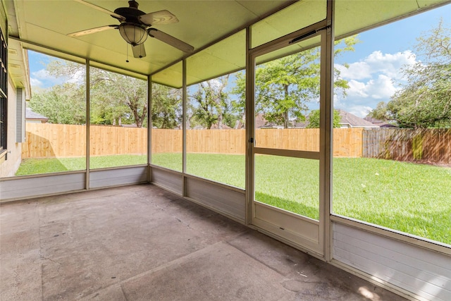 unfurnished sunroom with ceiling fan