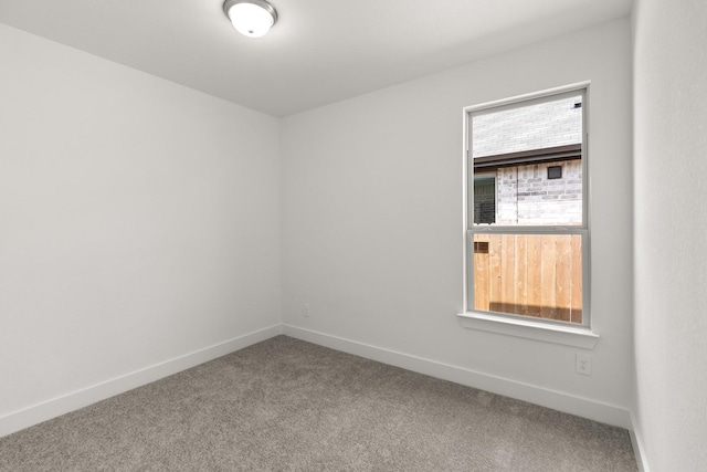 unfurnished room featuring baseboards and carpet floors
