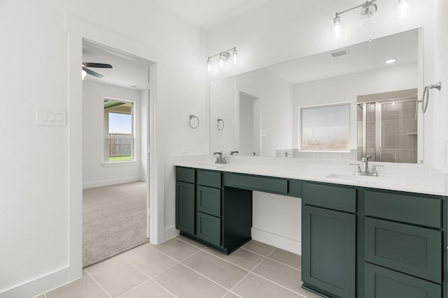 bathroom featuring a shower stall, a sink, double vanity, visible vents, and tile patterned flooring