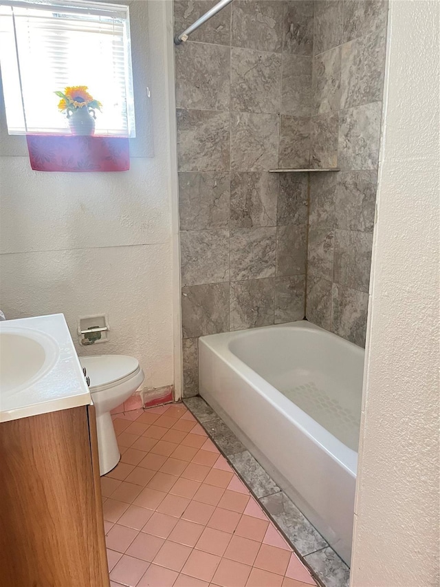 bathroom with a textured wall, toilet, shower / bath combination, tile patterned floors, and vanity