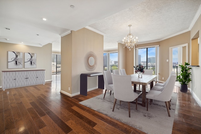 dining space with wood finished floors, a chandelier, ornamental molding, and baseboards