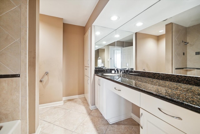 full bathroom featuring recessed lighting, a tile shower, tile patterned flooring, vanity, and baseboards