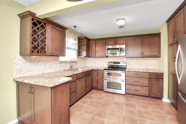 205 Bora Bora Dr, Tiki Island, TX 77554 - kitchen with stainless steel appliances, a sink, decorative backsplash, open shelves, and light stone counters