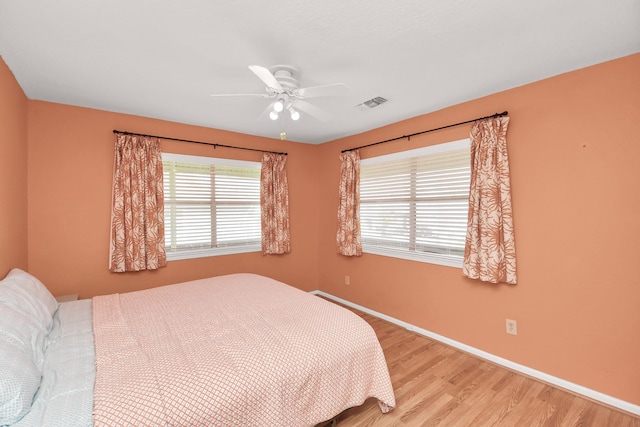 205 Bora Bora Dr, Tiki Island, TX 77554 - bedroom featuring light wood-style flooring, baseboards, and a ceiling fan