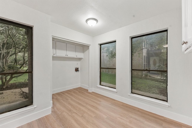 18118 Lakeside Ln, Houston, TX 77058 - laundry room with baseboards and light wood finished floors