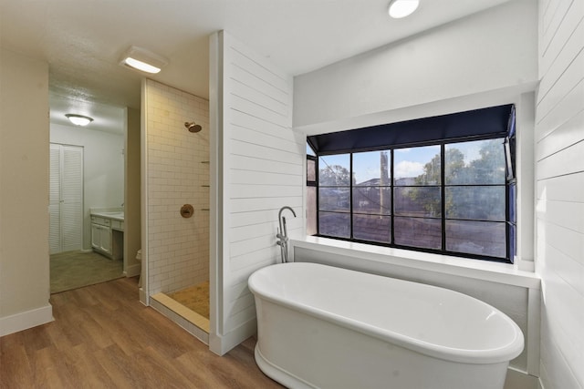 18118 Lakeside Ln, Houston, TX 77058 - bathroom with wood finished floors, a stall shower, a freestanding tub, and vanity