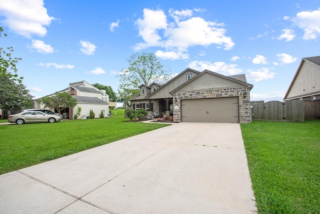 craftsman-style house with driveway, stone siding, a front yard, an attached garage, and fence