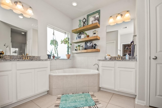bathroom featuring recessed lighting, tile patterned floors, two vanities, a bath, and visible vents