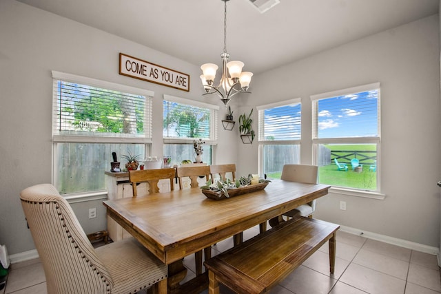 dining area with baseboards, visible vents, an inviting chandelier, and light tile patterned flooring