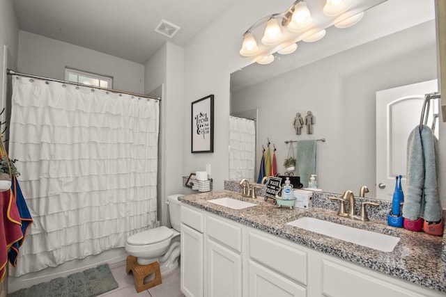 bathroom featuring toilet, tile patterned flooring, a sink, and visible vents
