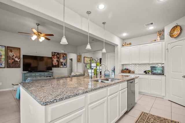 kitchen featuring a sink, light tile patterned flooring, ceiling fan, visible vents, and dishwasher