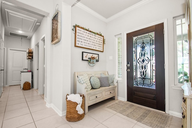 entryway with light tile patterned floors, visible vents, ornamental molding, and baseboards