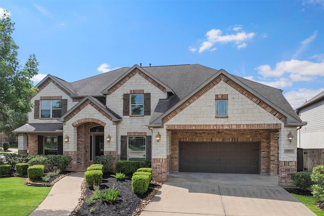27803 Indigo Pointe Ln, Katy, TX 77494 - french country inspired facade with driveway, a shingled roof, stone siding, brick siding, and an attached garage