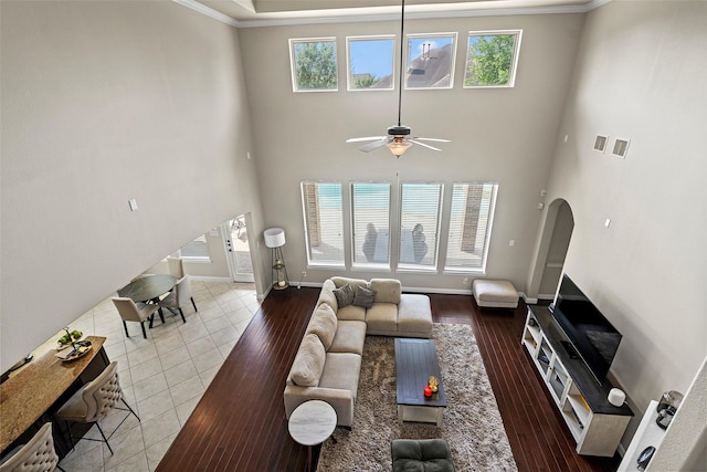 27803 Indigo Pointe Ln, Katy, TX 77494 - tiled living area featuring a ceiling fan, crown molding, healthy amount of natural light, baseboards, and arched walkways