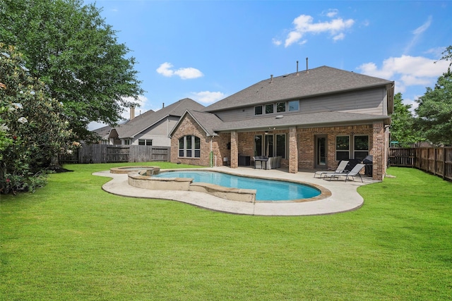 27803 Indigo Pointe Ln, Katy, TX 77494 - rear view of property featuring brick siding, a patio area, a pool with connected hot tub, and a shingled roof