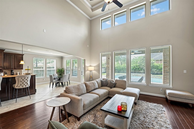 27803 Indigo Pointe Ln, Katy, TX 77494 - living area with ornamental molding, a towering ceiling, healthy amount of natural light, ceiling fan, and baseboards