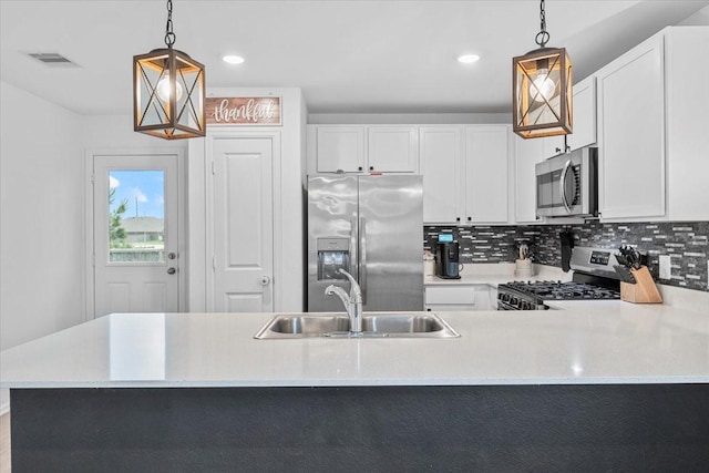 126 Spring Rose Dr, Magnolia, TX 77354 - kitchen featuring appliances with stainless steel finishes, a sink, light countertops, tasteful backsplash, and recessed lighting