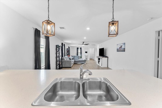 126 Spring Rose Dr, Magnolia, TX 77354 - kitchen with a sink, a ceiling fan, light countertops, recessed lighting, and hanging light fixtures