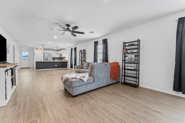 126 Spring Rose Dr, Magnolia, TX 77354 - living room featuring light wood-style floors, ceiling fan, recessed lighting, and baseboards