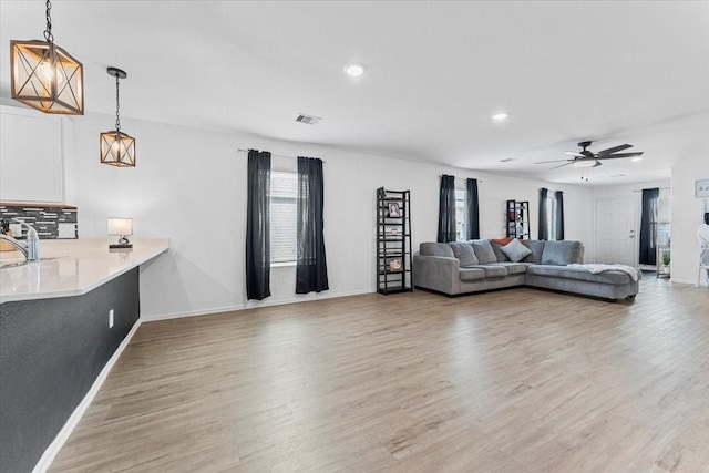 126 Spring Rose Dr, Magnolia, TX 77354 - living room featuring light wood finished floors, baseboards, ceiling fan, and recessed lighting