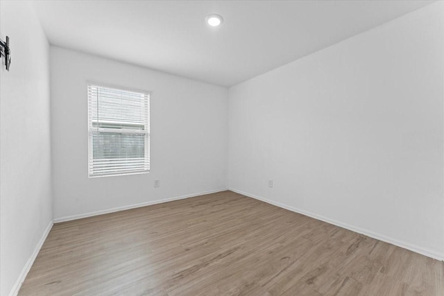 126 Spring Rose Dr, Magnolia, TX 77354 - empty room featuring light wood-style floors, baseboards, and recessed lighting