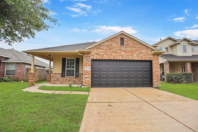 view of front facade with a garage, fence, a front yard, brick siding, and driveway