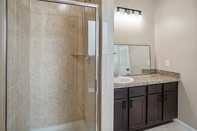 full bath with vanity and a shower stall