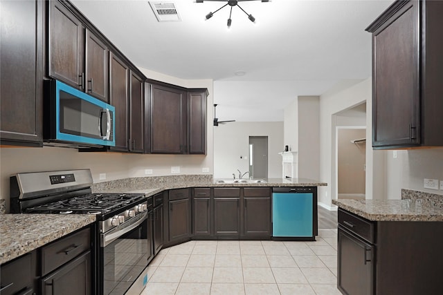 kitchen with visible vents, stainless steel range with gas stovetop, dark brown cabinets, a sink, and dishwasher