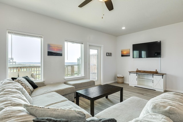 living area with baseboards, recessed lighting, wood finished floors, and ceiling fan