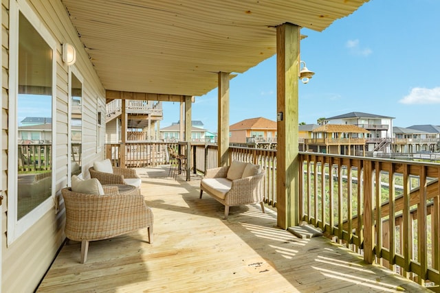 view of wooden balcony with a deck, a residential view, and outdoor lounge area