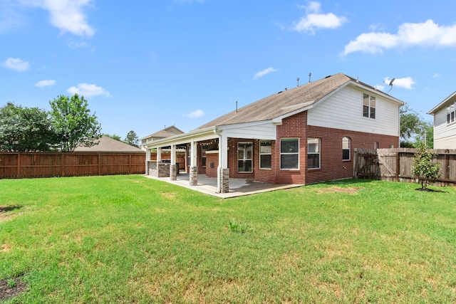 back of property featuring a patio, a lawn, a fenced backyard, and brick siding