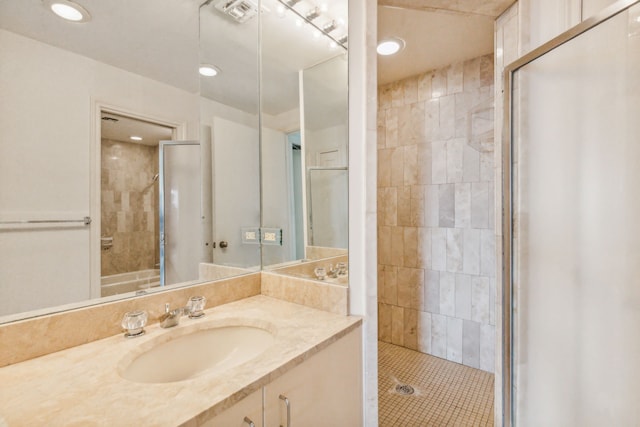 101 Westcott St Unit 1402, Houston, TX 77007 - bathroom with a tile shower, vanity, recessed lighting, and tile patterned flooring