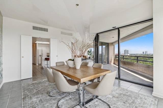 101 Westcott St Unit 1402, Houston, TX 77007 - dining room with tile patterned flooring, baseboards, and a city view