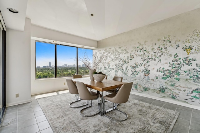 101 Westcott St Unit 1402, Houston, TX 77007 - dining space with tile patterned flooring, vaulted ceiling, a city view, and baseboards