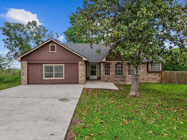 307 Binnacle Way, Crosby, TX 77532 - ranch-style home featuring fence, roof with shingles, a front lawn, and brick siding