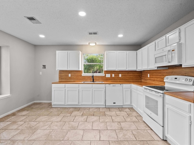 307 Binnacle Way, Crosby, TX 77532 - kitchen with a sink, white cabinets, white appliances, and visible vents