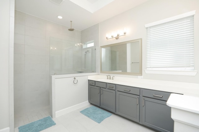 full bath featuring tile patterned flooring, visible vents, a walk in shower, and vanity