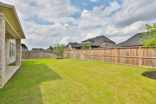 view of yard with a fenced backyard