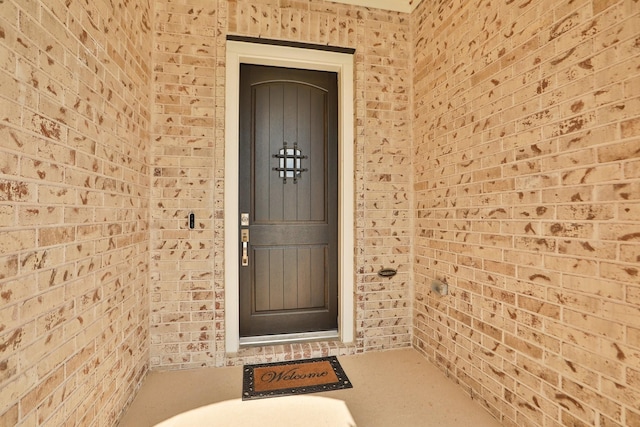 property entrance with brick siding