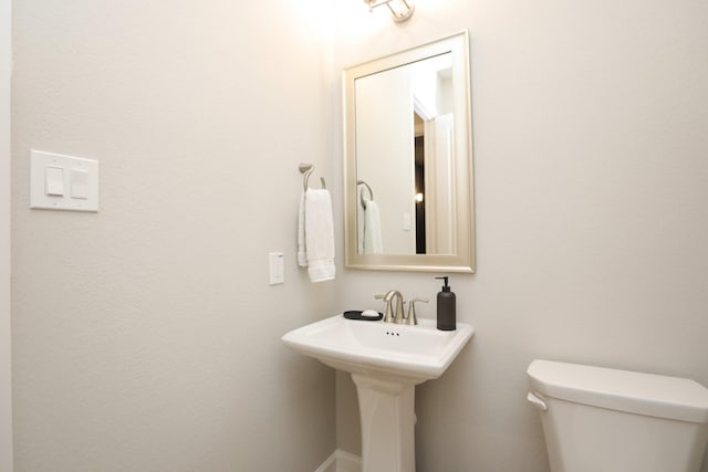 half bathroom featuring toilet
